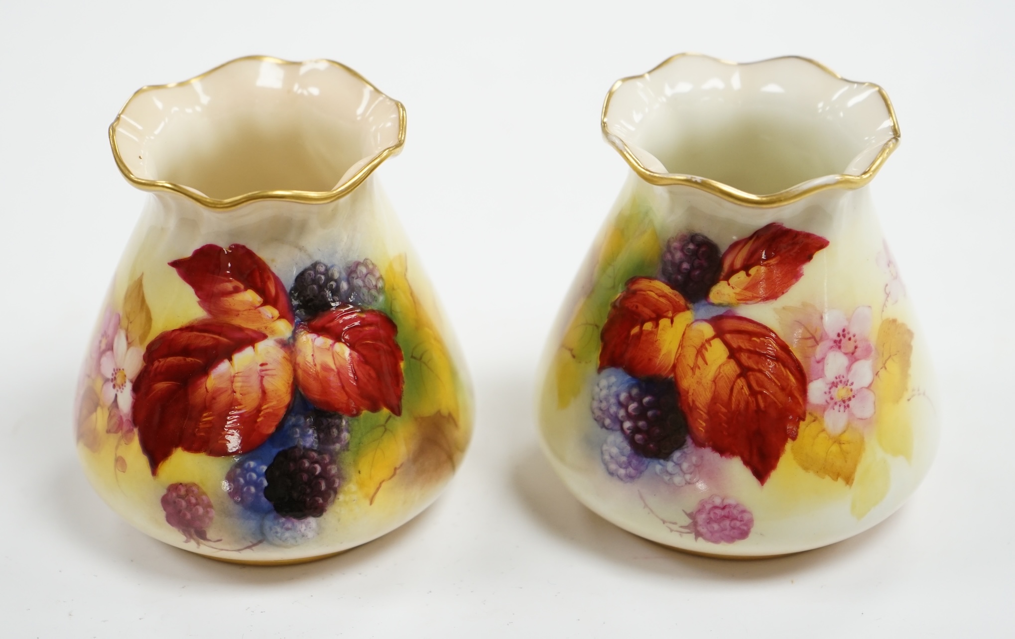 A pair of Worcester K. Blake pots, 8cm high. Condition - some gilding missing